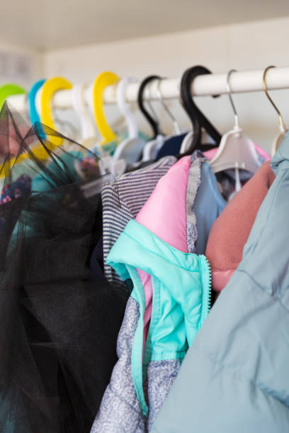 istock Hangers with different clothes in wardrobe closet. 1388193015