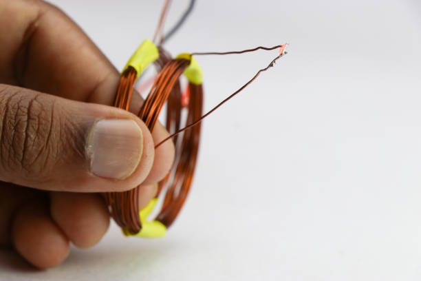 istock Prototype of wireless electricity transmission project held in hand on a white background 1388194470