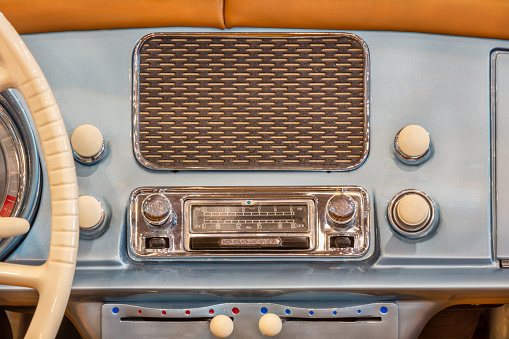 Old transistor radio on wooden background.