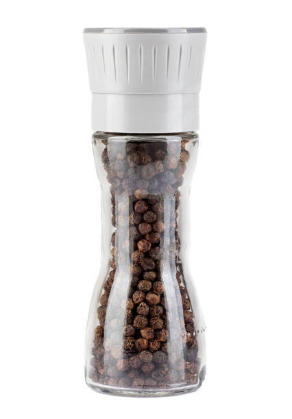 istock A glass mill with black pepper inside is isolated on a white background. 1388197668