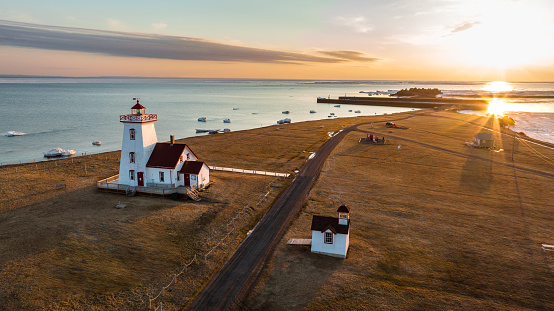 Aerial drone photograph of Wood Islands Lighthouse on Prince Edward Island at golden hour sunset in winter