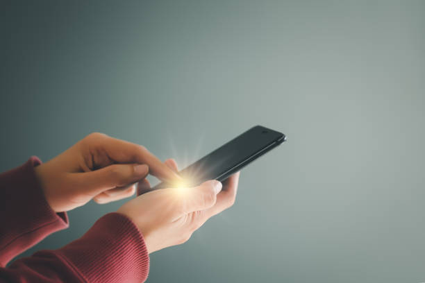 istock Woman using mobile smartphone for Internet connection, social media, online shopping, social networking, Point finger on screen mobile phone closeup. 1388198772
