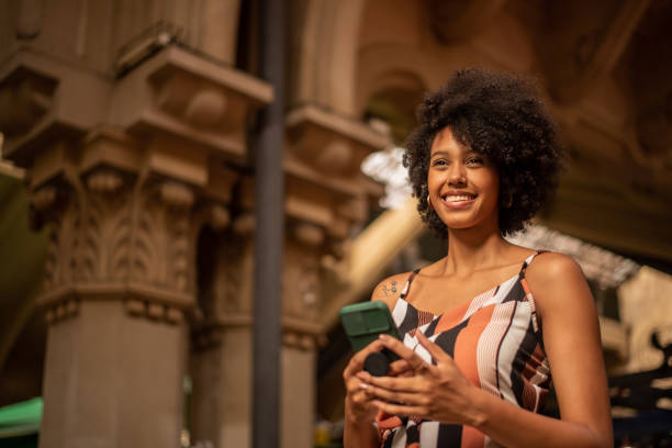 istock Tourist using cell phone in the city 1388198924