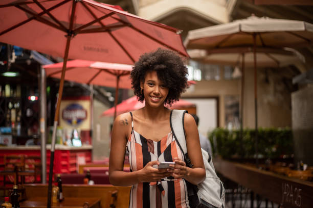 istock Tourist using cell phone in the city 1388198937