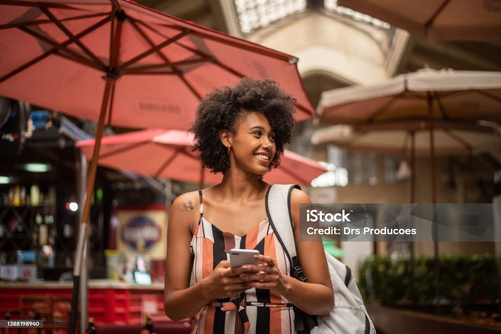 Tourist using cell phone in the city Municipal market, city of Sao Paulo, day, relaxed clothes One Woman Only Stock Photo