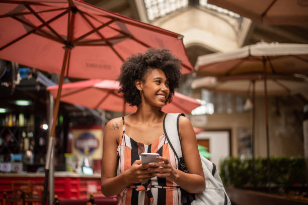 Tourist using cell phone in the city Municipal market, city of Sao Paulo, day, relaxed clothes brazilian ethnicity stock pictures, royalty-free photos & images