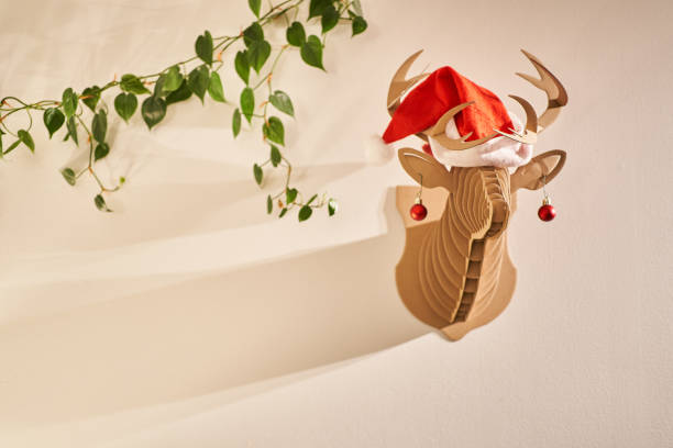 istock Reindeer bust hanging on a wall wearing a Santa hat 1388198999
