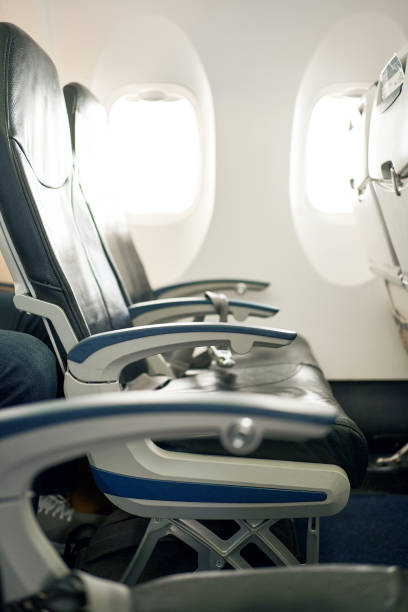 istock Row of empty airplane seats on a small commercial flight 1388199021