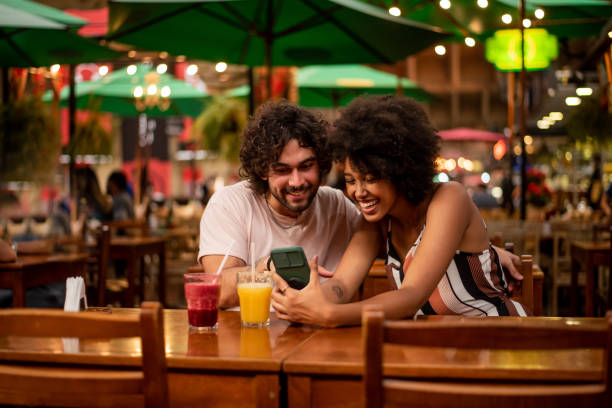 istock Couple using cell phone in the city 1388199761