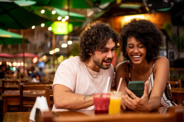 istock Couple using cell phone in the city 1388199763