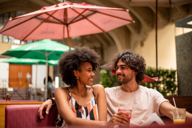 istock Couple drinking juice at restaurant 1388199778