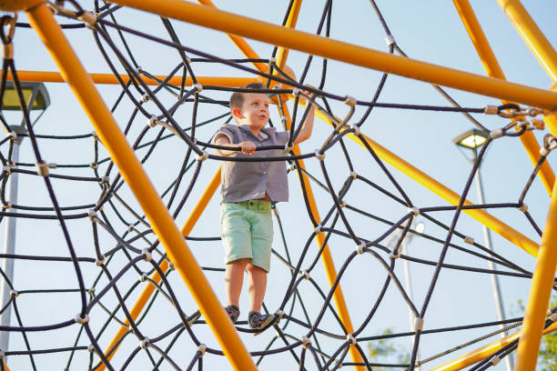 istock Cheerful Happy boy having fun in the park on a sunny day 1388199796