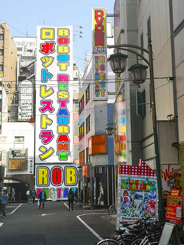April 6, 2019 - Tokyo, Japan: Japanese architecture of stacked street signs on multi-story buildings, in the beautiful Shinjuku Kabukicho neighborhood, including the famous Robot Restaurant sign.