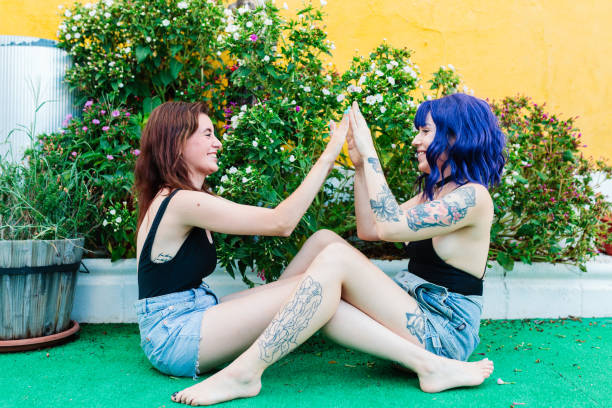 istock Happy young women playing patty cake in backyard 1388201086