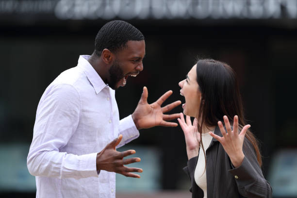 istock Interracial couple arguing in the street 1388201523