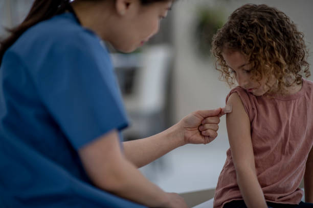 istock Pediatrician Applying a Bandage 1388201594