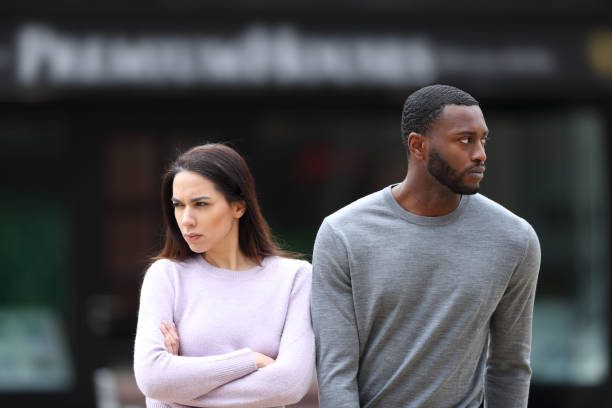 istock Angry interracial couple ignoring each other 1388201629