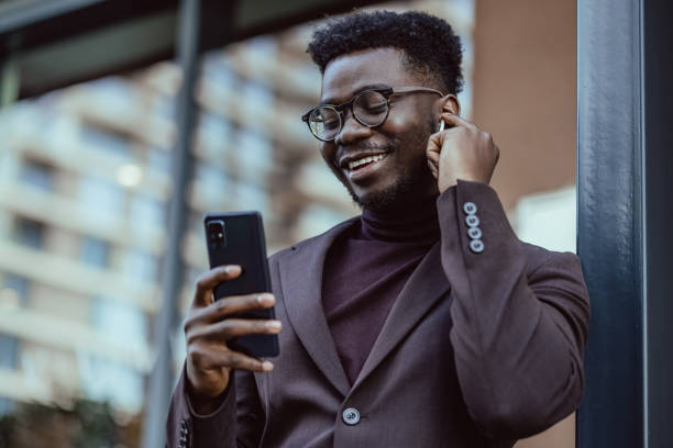 istock Good looking African-American businessmen using smartphone 1388202815