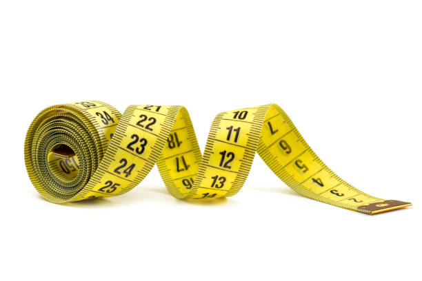istock Yellow measuring tape isolated on white background 1388204147