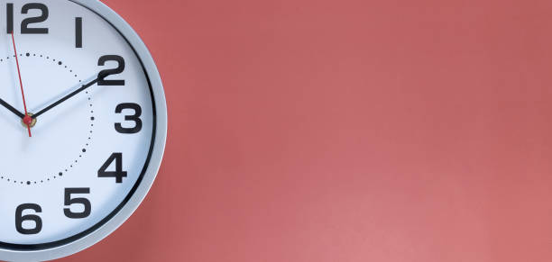 istock Clock on a red background, the concept of time management, time planning. Web banner, free space. 1388205432