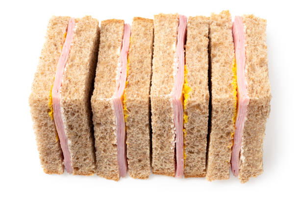 istock Row of ham and mustard wholewheat triangle sandwiches 1388205990