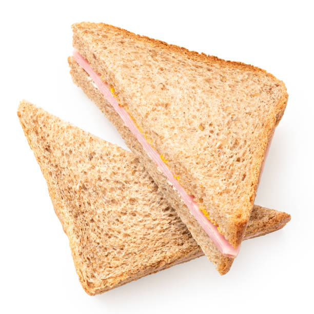 istock Two ham and mustard wholewheat triangle sandwiches from above. 1388206013