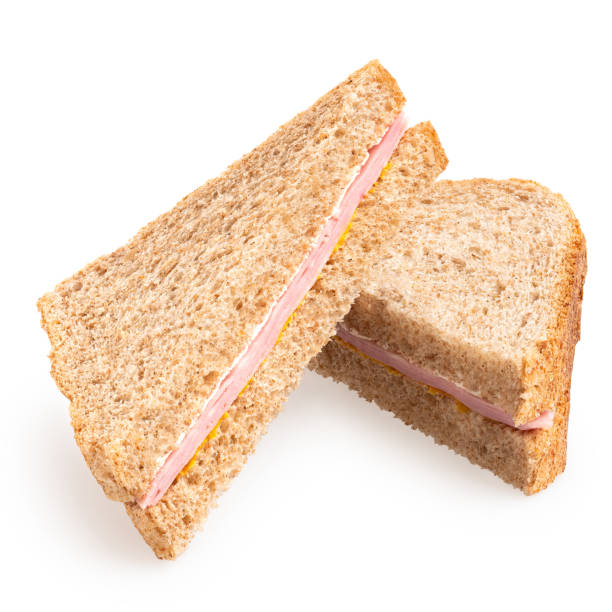 istock Two ham and mustard wholewheat triangle sandwiches. 1388206043
