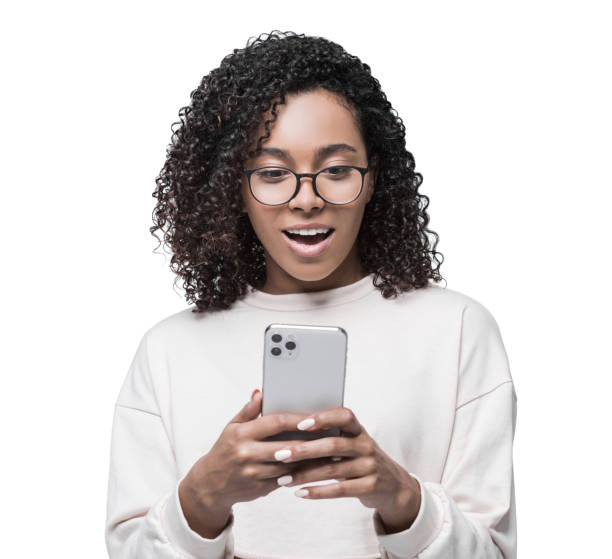 istock Excited surprised girl using smart phone, isolated 1388207394