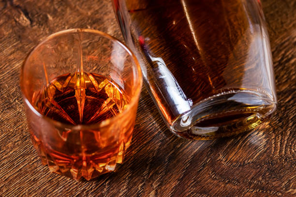 istock A glass of whiskey and a bottle lying on the table 1388208455