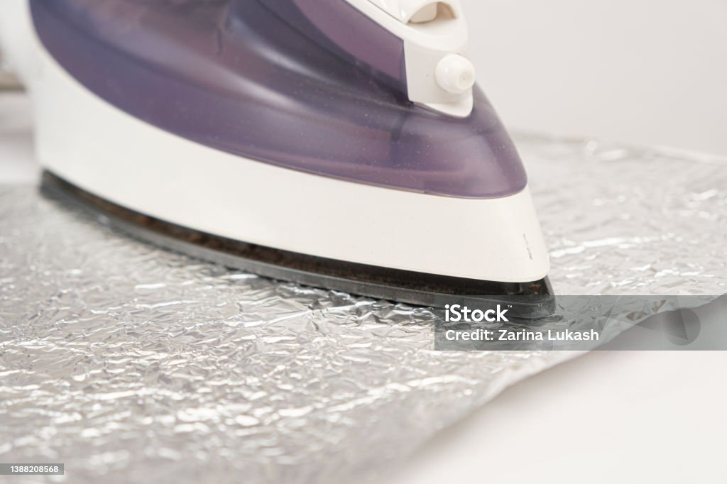 The Iron Irons The Foil On A White Background Stock Photo - Download