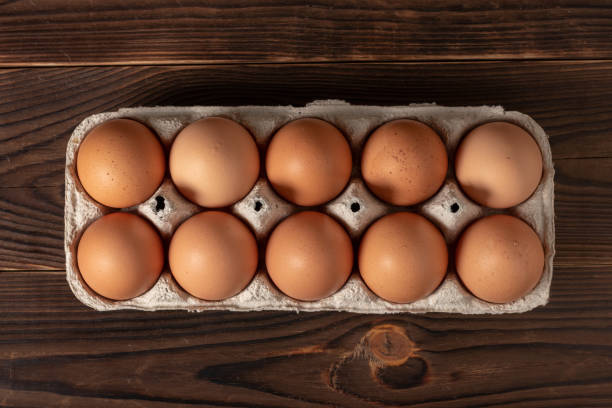 istock Happy Easter. Easter eggs. Chicken brown eggs closeup top view On the table. A carton crate of fresh brown eggs. Organic chicken eggs in a egg carton. 1388209096
