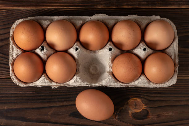 istock Happy Easter. Easter eggs. Chicken brown eggs closeup top view On the table. A carton crate of fresh brown eggs. Organic chicken eggs in a egg carton. 1388209125