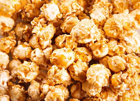 Caramel popcorn snack background texture. Close up. Top view