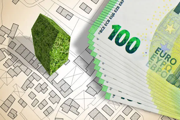 Green building costs concept with an imaginary city map - The architecture of the future "nconcept with European euro banknote
