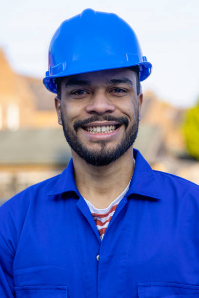 A teenager in industrial work clothing.