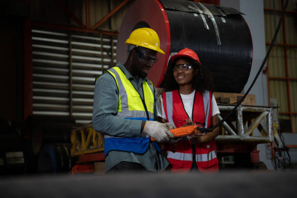 istock Two technicians Inspecting and testing the operation of lifting cranes in heavy industrial plants. 1388214951