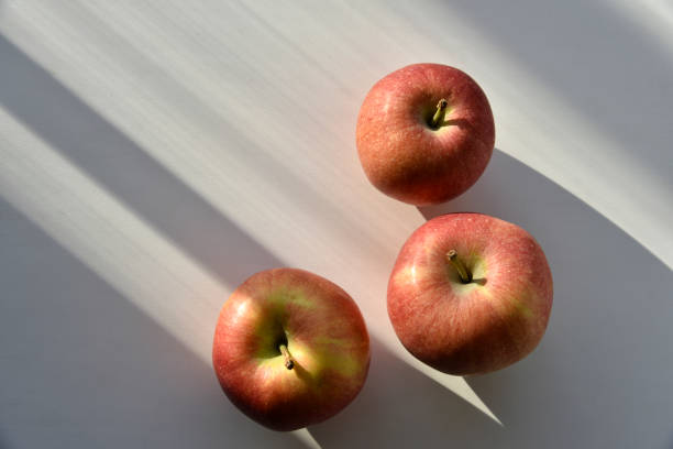 istock A red and yellow apple in the shadows on the windowsill 1388217162