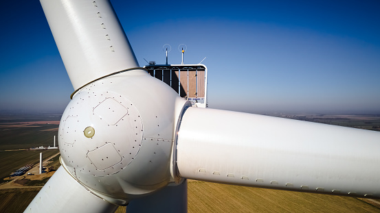 Aerial view of close up windmill turbine in countryside area, Wind power and renewable sustainable energy concept