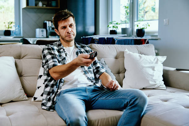 istock Man watching TV at home 1388223516