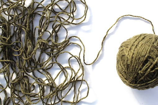 Large ball of elastic bands, collected over many years and beginning to perish.