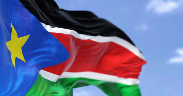 Detail of the national flag of South Sudan waving in the wind on a clear day Detail of the national flag of South Sudan waving in the wind on a clear day. South Sudan is a landlocked country in central Africa. Selective focus. south sudan stock pictures, royalty-free photos & images