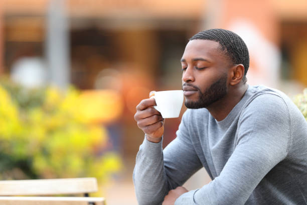 istock Man with black skin relaxing drinking coffee in a bar 1388226207