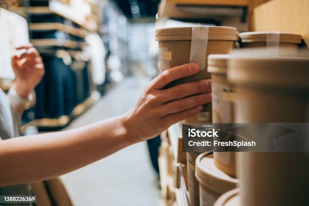 A Close Up Shot Of An Anonymous Caucasian Woman In A Shop Holding A Biodegradable Package Of Some Product Deciding Whether To Buy It Or Not Stock Photo - Download Image Now