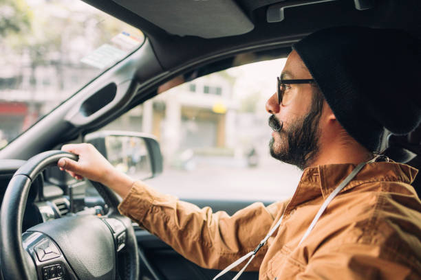 istock A Focused Casually Dressed Man With Moustaches Driving Through The City 1388227980