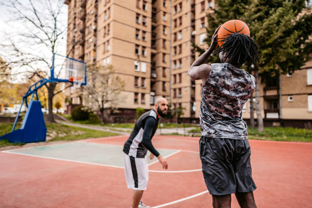istock Two Young Men Playing Basketball 1388229543