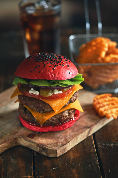 istock Red Bun Double Beef Burger with Tomato, Cheese, Avocado, Pickles Served with Chip Fries 1388229801
