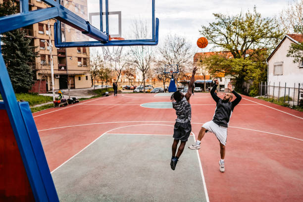 istock Two Young Men Playing Basketball 1388230801