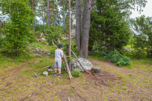 istock Beautiful view of young boy playing in forest. 1388231123