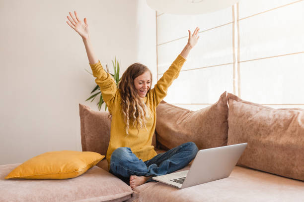 istock Excited young woman looking at laptop screen, celebrating win 1388232128