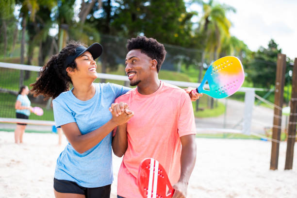 istock Couple playing beach tennis 1388234225